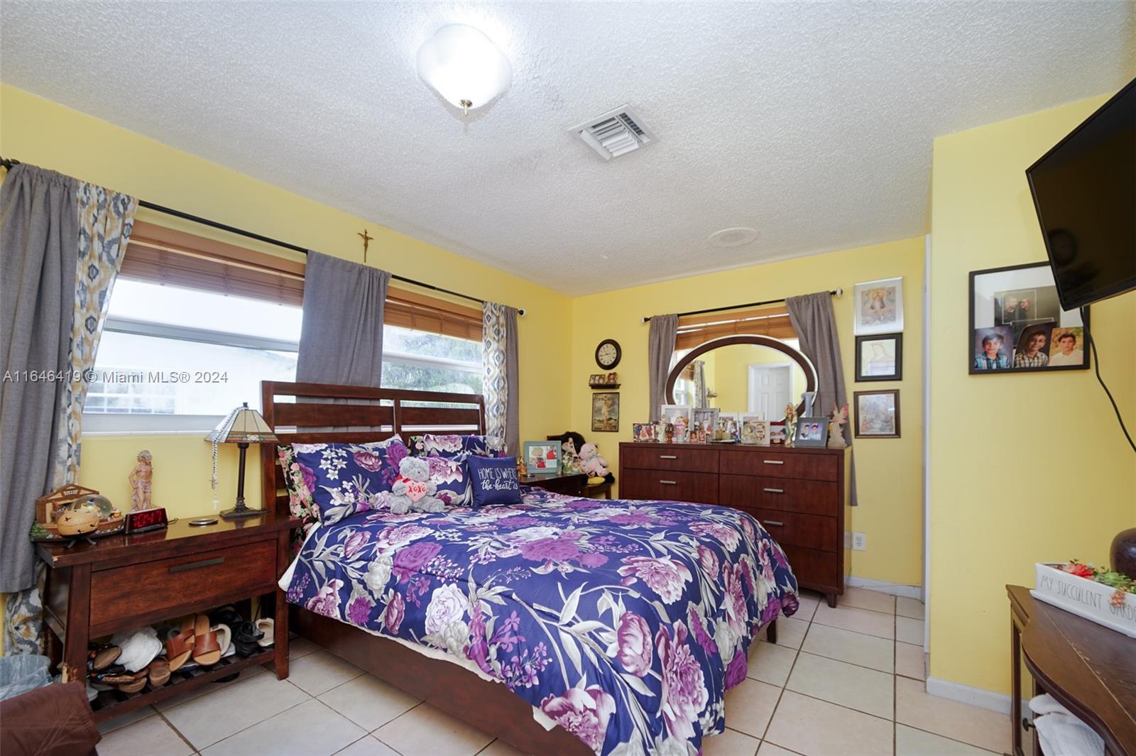 18400 Northeast 7th Court North Miami Beach, FL 33179 - Photo 11 of 24 a bedroom with a bed and wooden floor