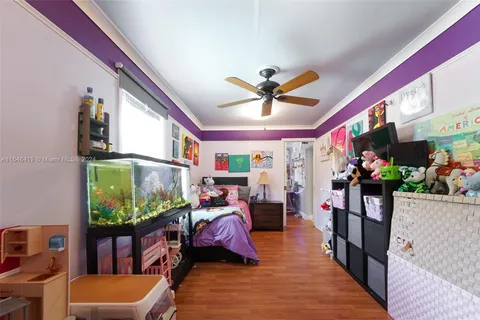 a living room filled with furniture hardwood floor and a flat screen tv