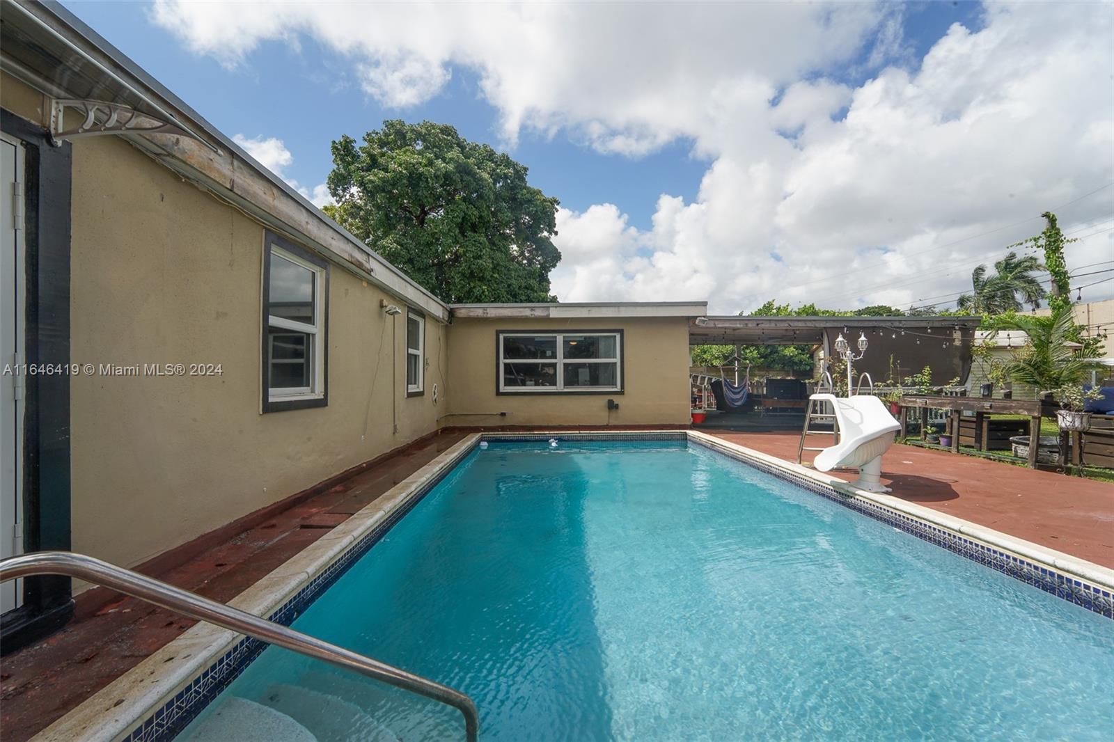 18400 Northeast 7th Court North Miami Beach, FL 33179 - Photo 17 of 24 a view of backyard with swimming pool and porch