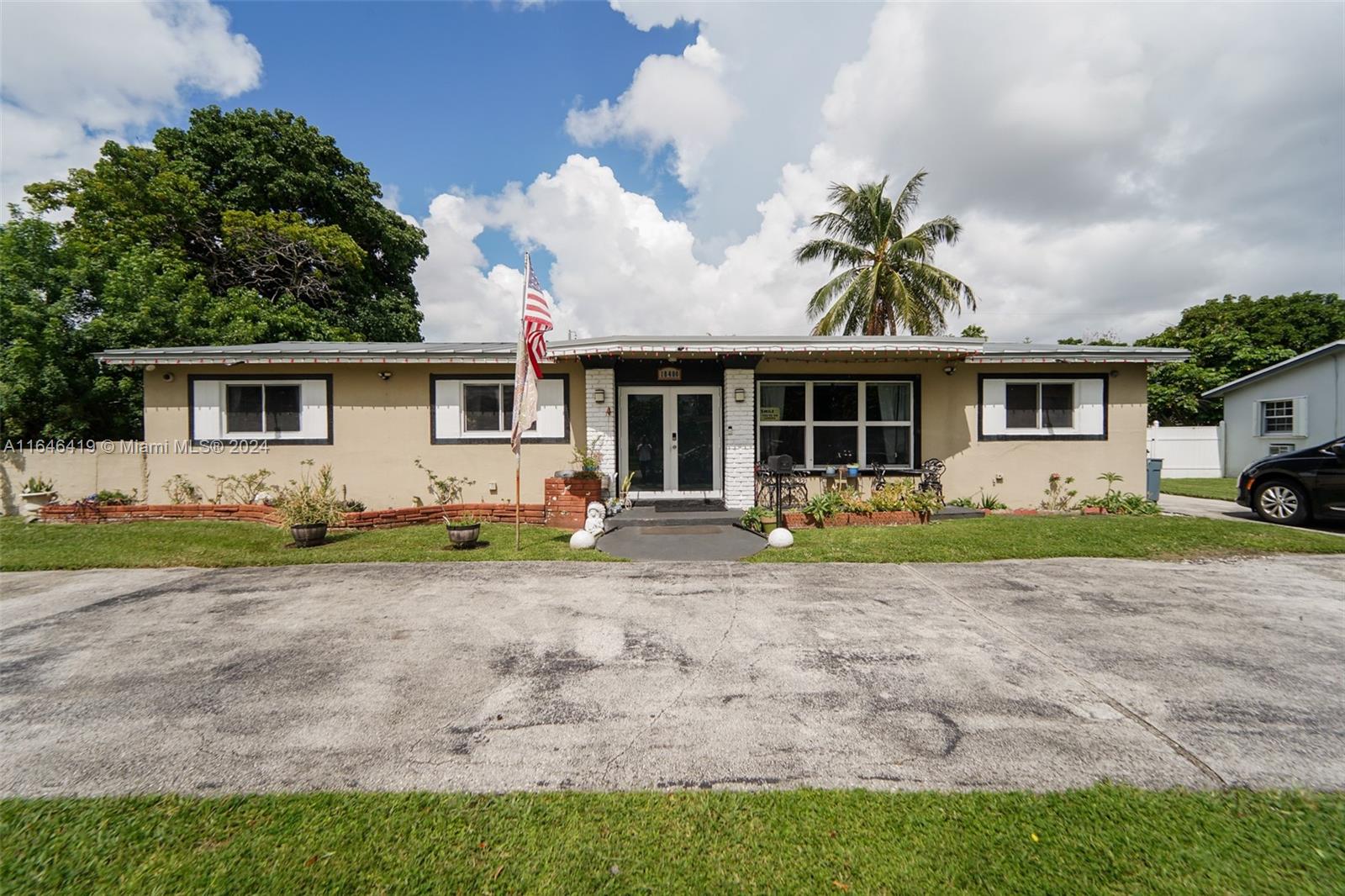 18400 Northeast 7th Court North Miami Beach, FL 33179 - Photo 22 of 24 a front view of house with yard and green space
