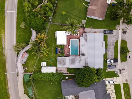 an aerial view of a house with a yard and potted plants