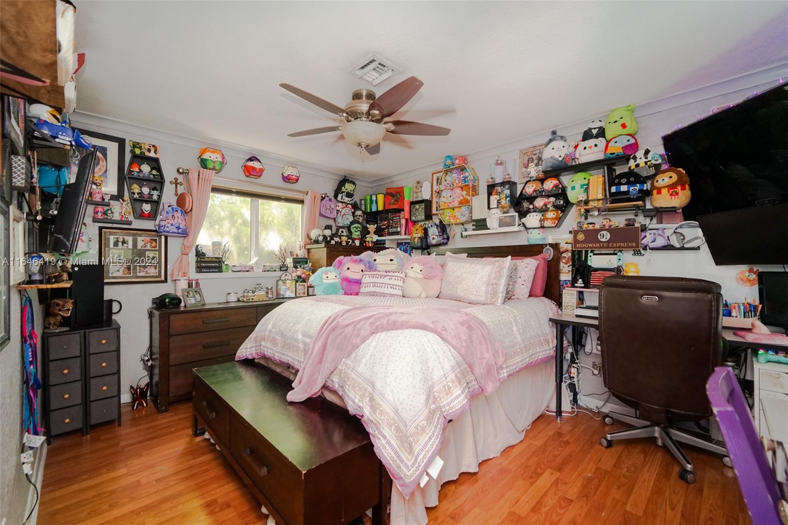 18400 Northeast 7th Court North Miami Beach, FL 33179 - Photo 7 of 24 a bed room with a bed and a book shelf