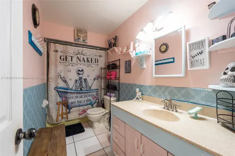 a bathroom with a sink mirror and vanity