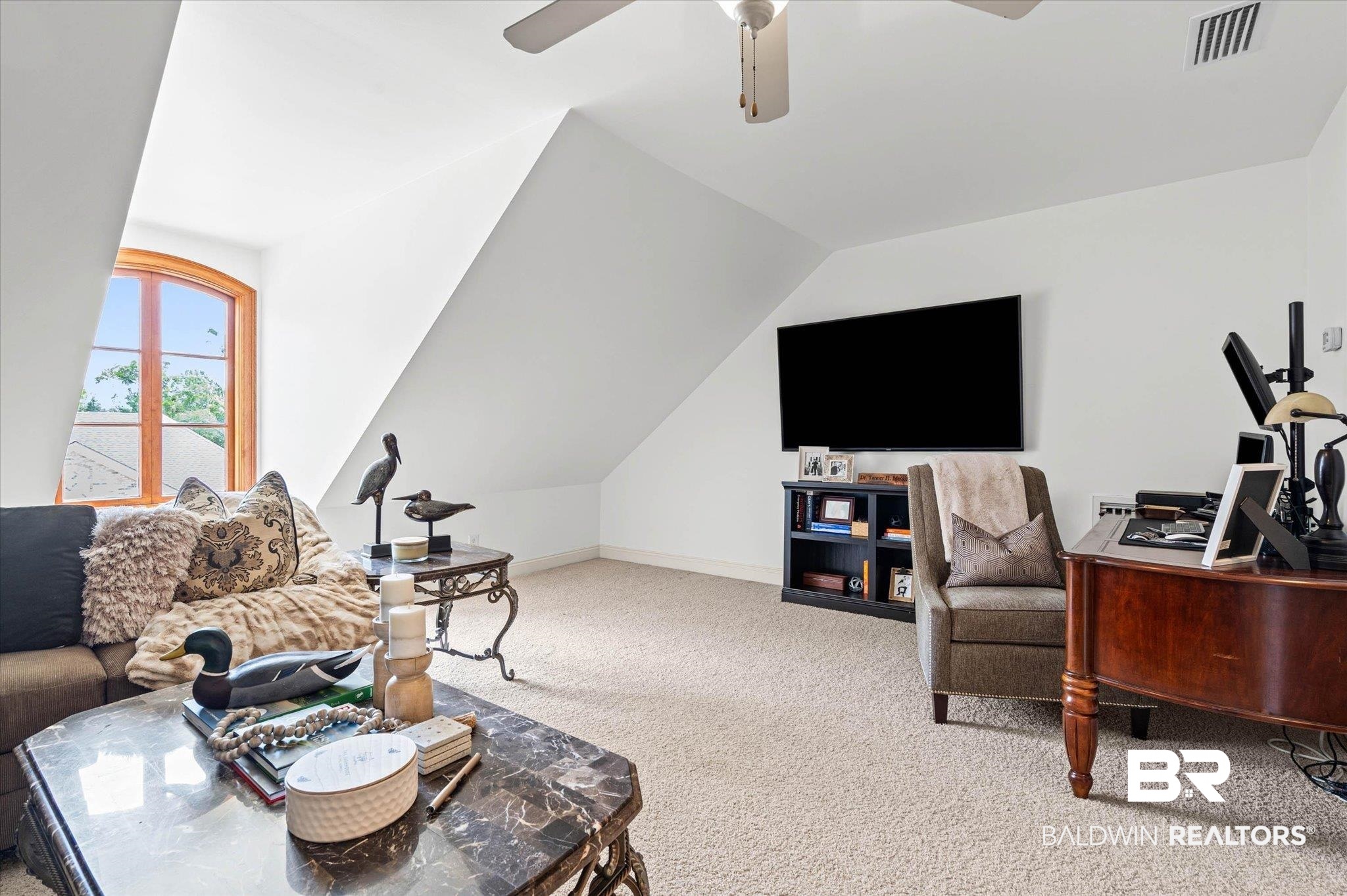 3459 Rue Royal Mobile, AL 36693 - Photo 25 of 31 Carpeted room with a vaulted ceiling and an arched window featuring wood trim