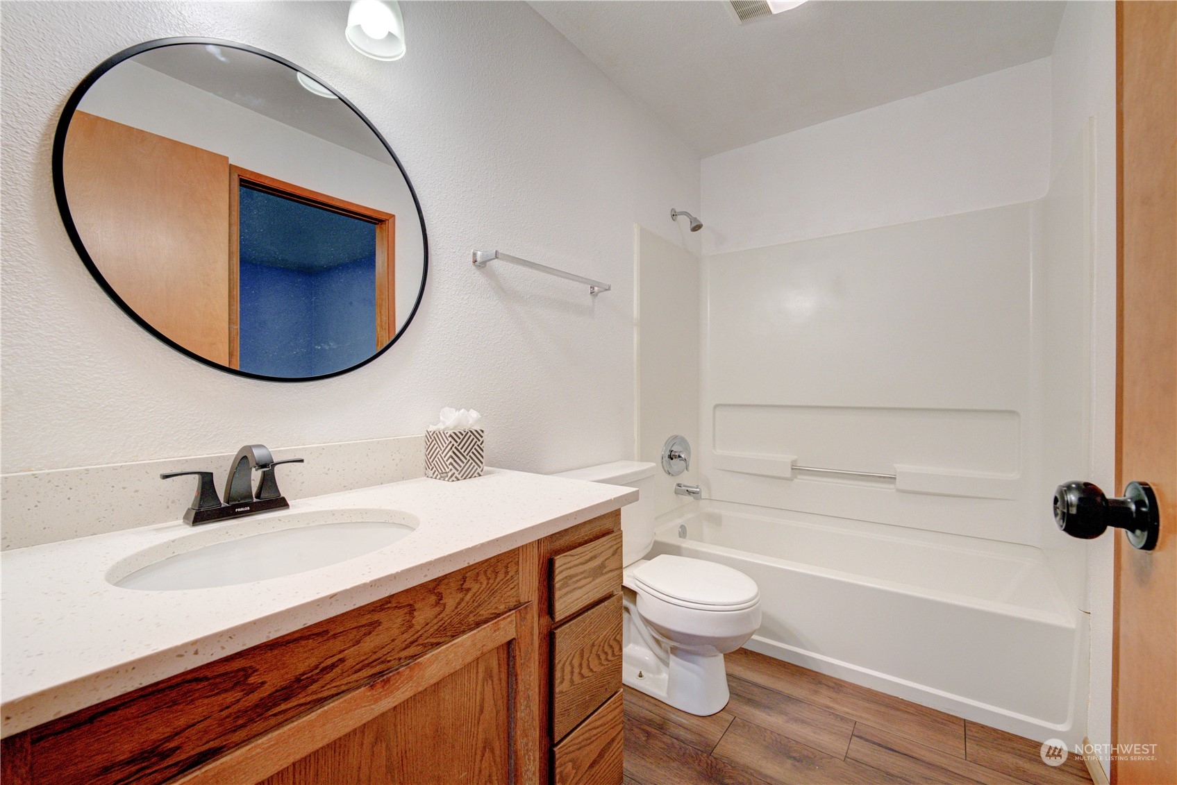 18910 Bothell Everett Highway, Unit J3 Bothell, WA 98012 - Photo 27 of 33 a bathroom with a sink a toilet and a mirror