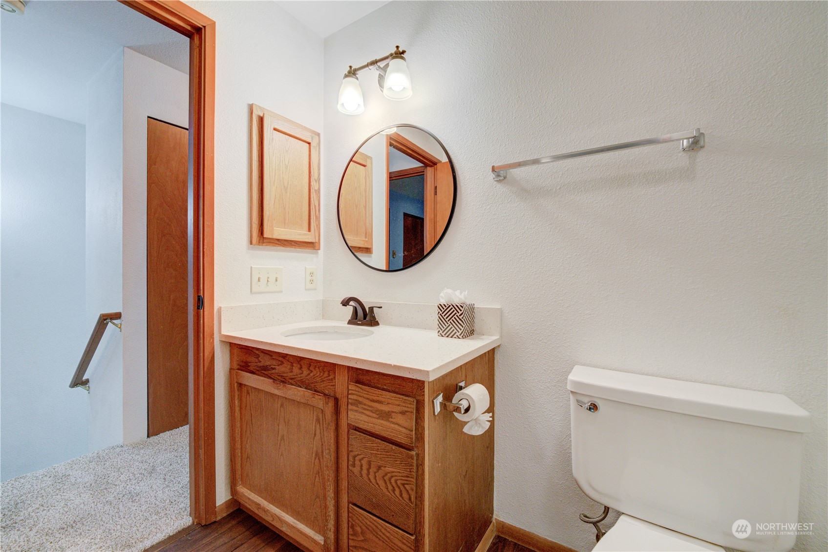 18910 Bothell Everett Highway, Unit J3 Bothell, WA 98012 - Photo 28 of 33 a bathroom with a sink a toilet and a mirror