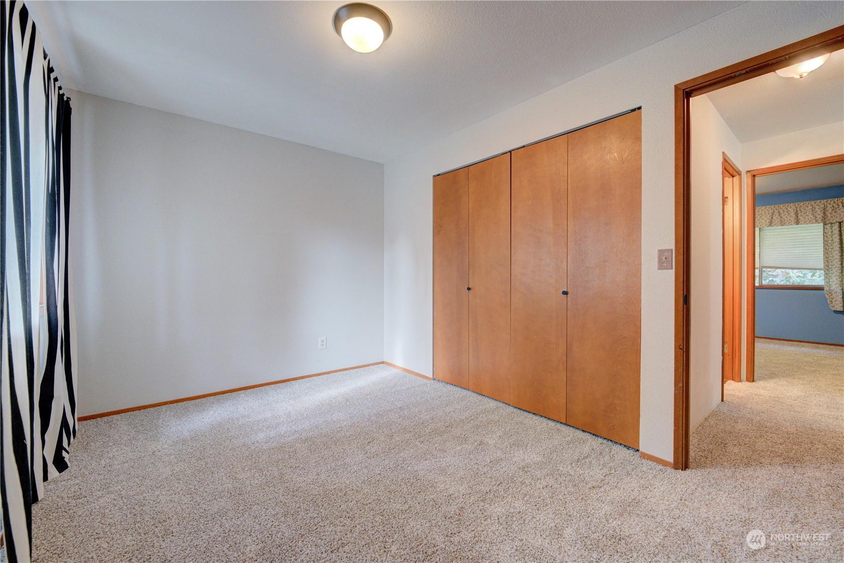 18910 Bothell Everett Highway, Unit J3 Bothell, WA 98012 - Photo 29 of 33 a view of an empty room and a window