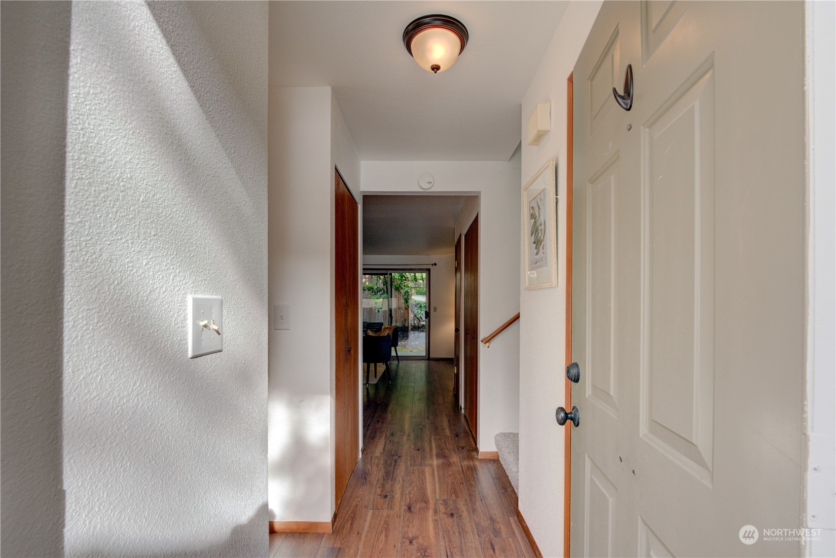 18910 Bothell Everett Highway, Unit J3 Bothell, WA 98012 - Photo 4 of 33 a view of a hallway with wooden floor