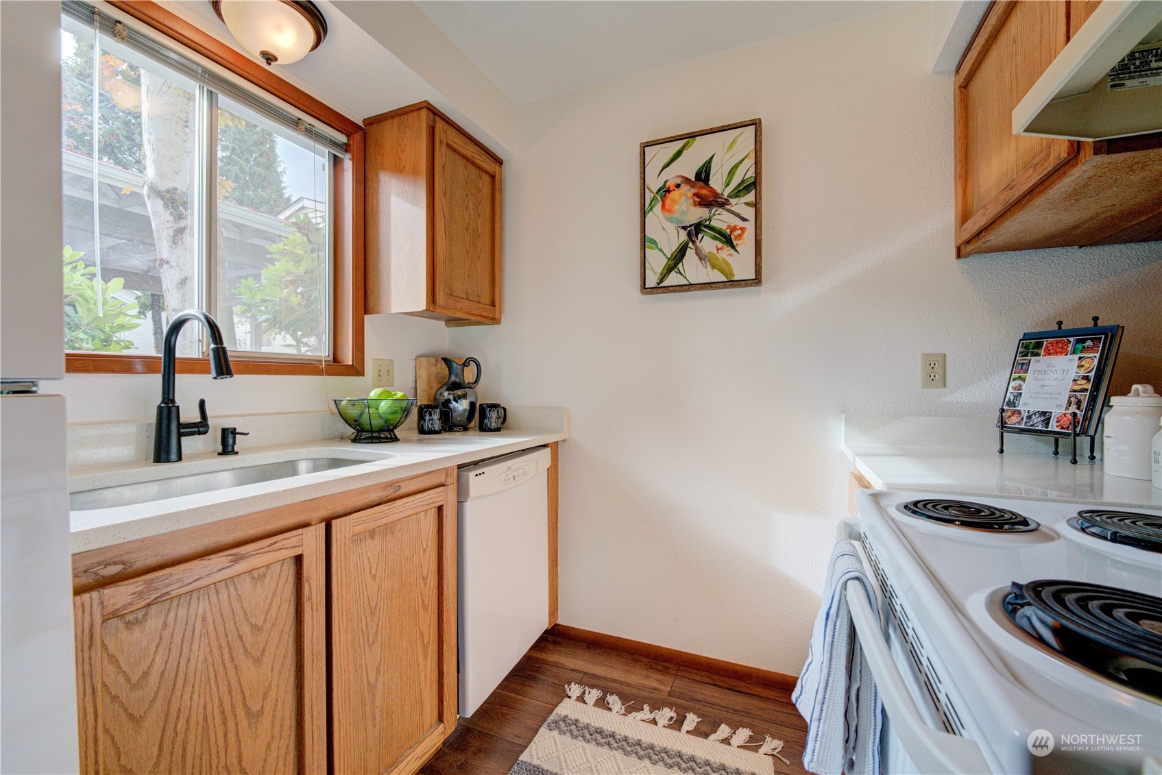 18910 Bothell Everett Highway, Unit J3 Bothell, WA 98012 - Photo 6 of 33 a kitchen with stainless steel appliances a sink a stove and a refrigerator