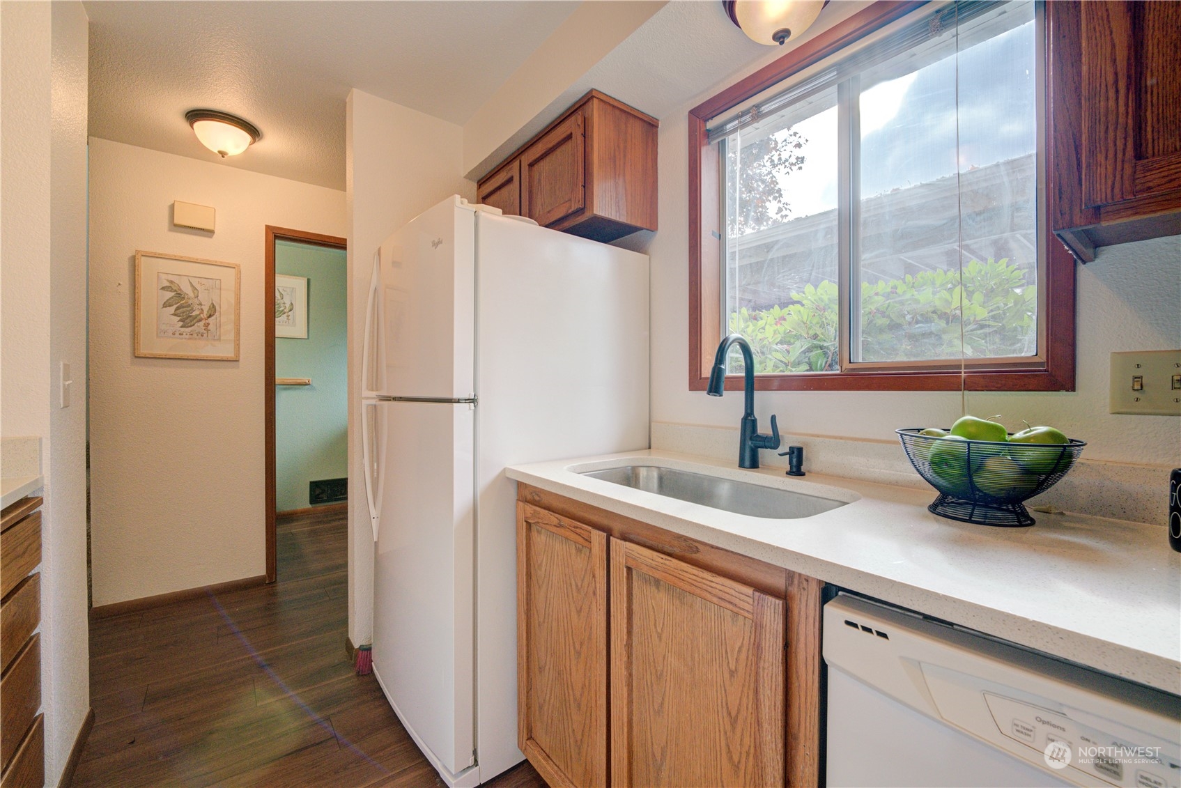 18910 Bothell Everett Highway, Unit J3 Bothell, WA 98012 - Photo 8 of 33 a kitchen with a sink and a refrigerator