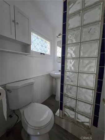 a white toilet sitting next to a window