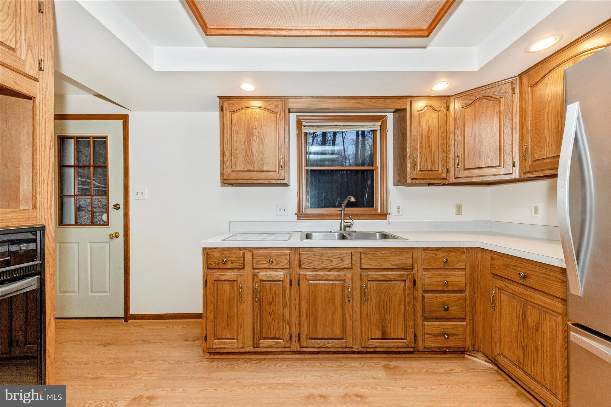 24607 Hells Delight Road Smithsburg, MD 21783 - Photo 14 of 47 a kitchen with stainless steel appliances granite countertop a sink and a stove top oven