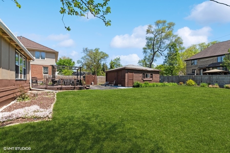 605 Revere Road Glenview, IL 60025 - Photo 15 of 18 a view of a house with backyard sitting area and garden