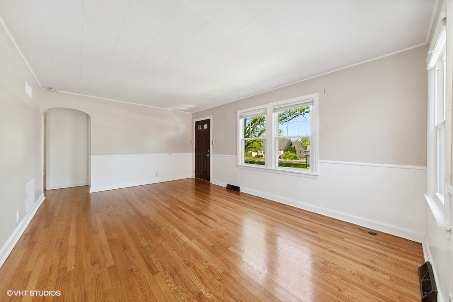 605 Revere Road Glenview, IL 60025 - Photo 2 of 18 a view of an empty room with wooden floor and a window