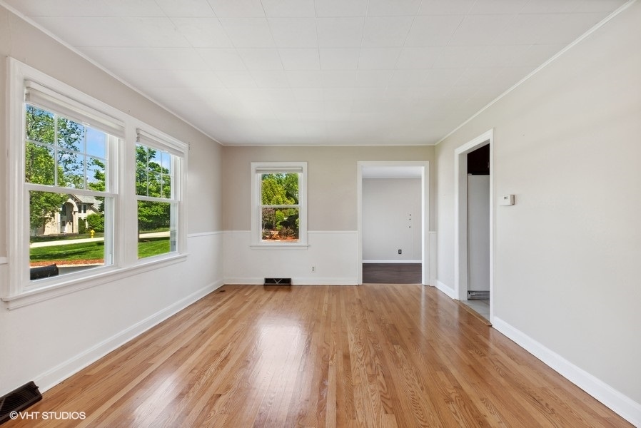 605 Revere Road Glenview, IL 60025 - Photo 3 of 18 a view of an empty room with wooden floor and a window