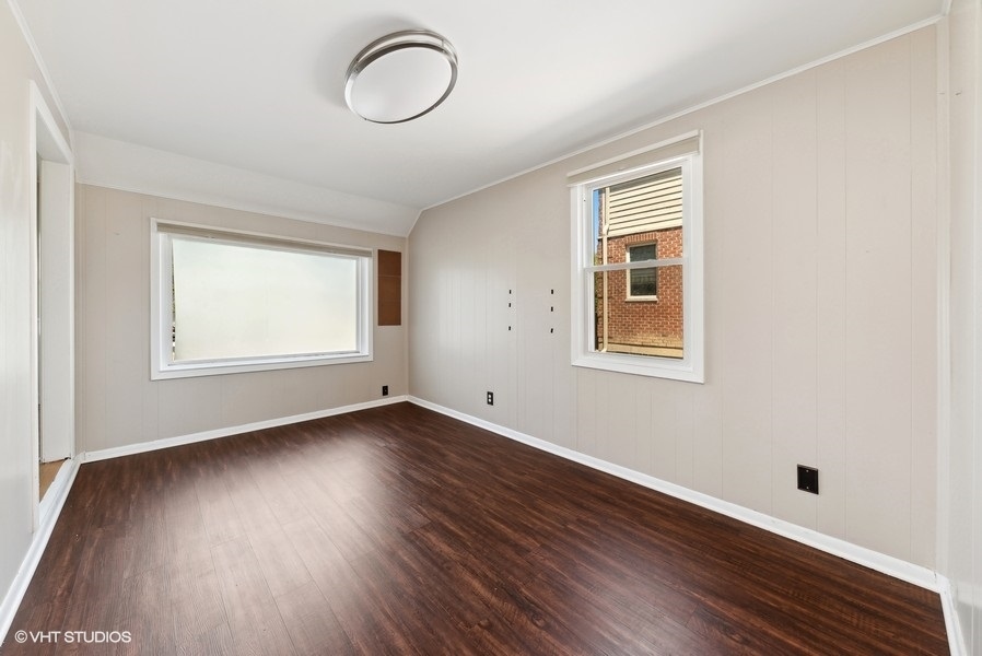 605 Revere Road Glenview, IL 60025 - Photo 5 of 18 a view of an empty room with wooden floor and a window