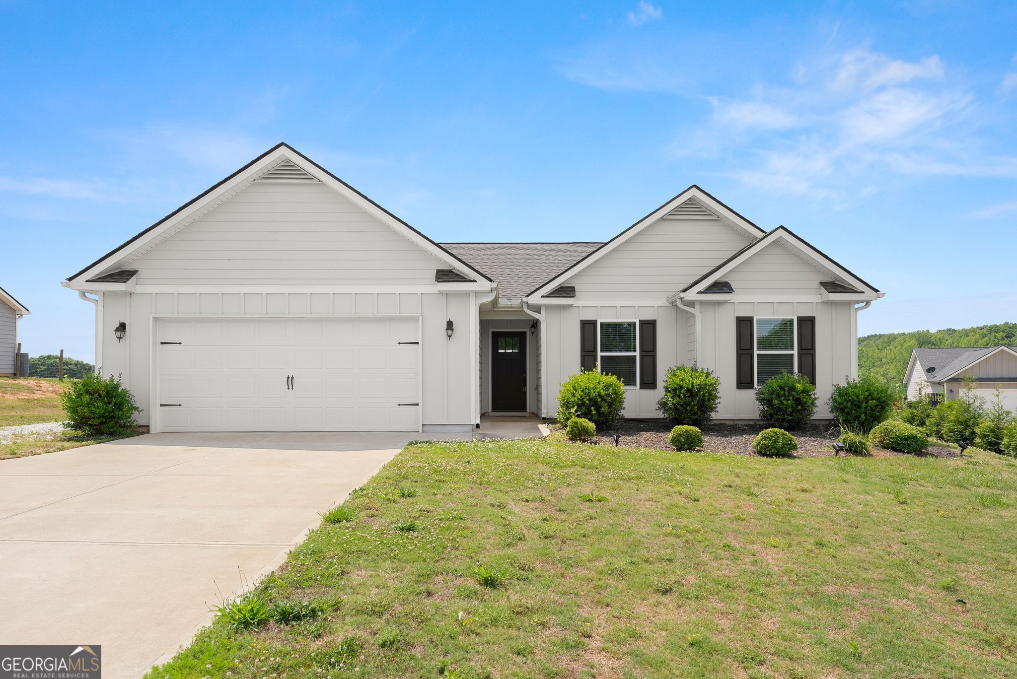 a front view of a house with a yard and garage