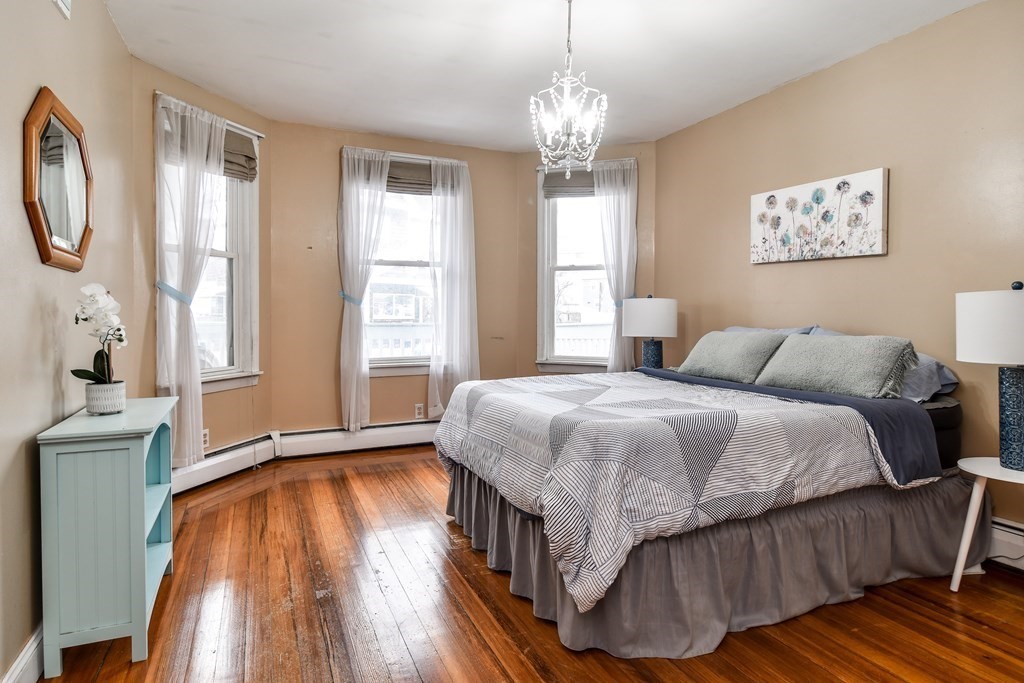 a spacious bedroom with a bed and a window