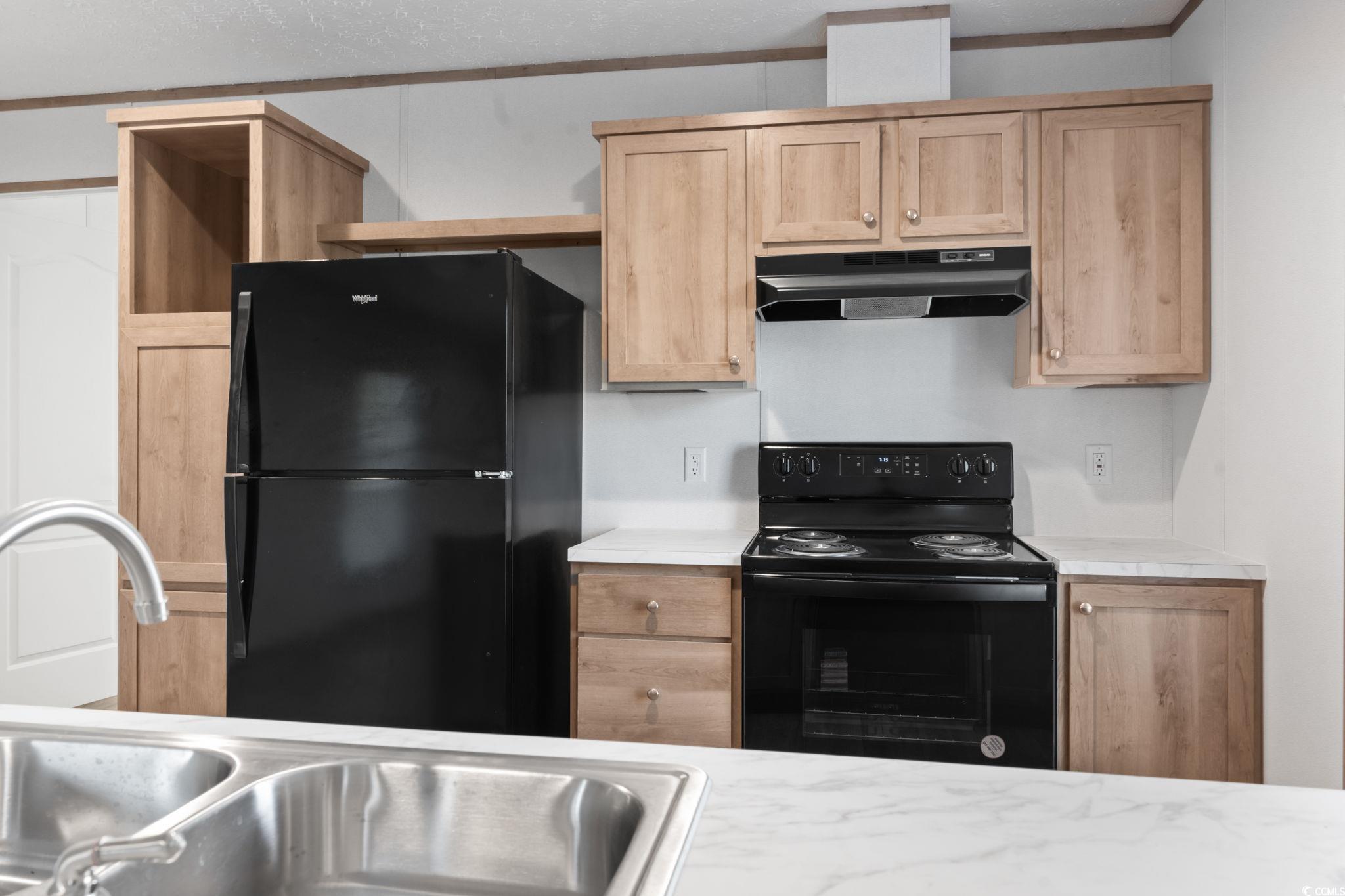 4448 Flat Bay Circle Myrtle Beach, SC 29588 - Photo 16 of 30 Kitchen with black appliances, crown molding, under cabinet range hood, open shelves, and light brown cabinetry
