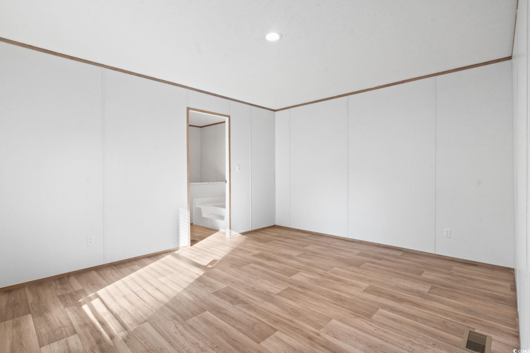4448 Flat Bay Circle Myrtle Beach, SC 29588 - Photo 19 of 30 Empty room featuring light wood finished floors, crown molding, and recessed lighting