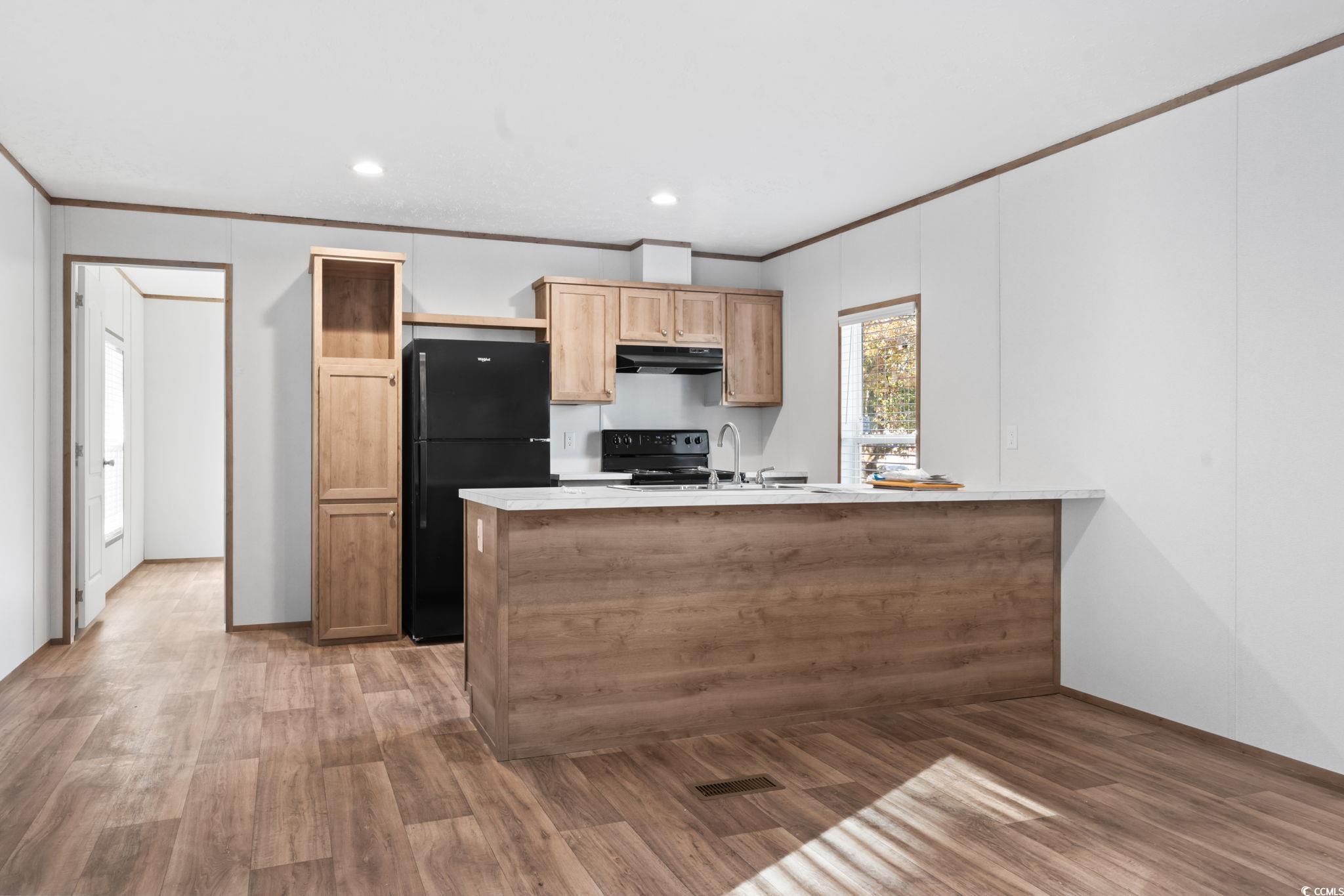 4448 Flat Bay Circle Myrtle Beach, SC 29588 - Photo 25 of 30 Kitchen with light countertops, crown molding, black appliances, a peninsula, and recessed lighting