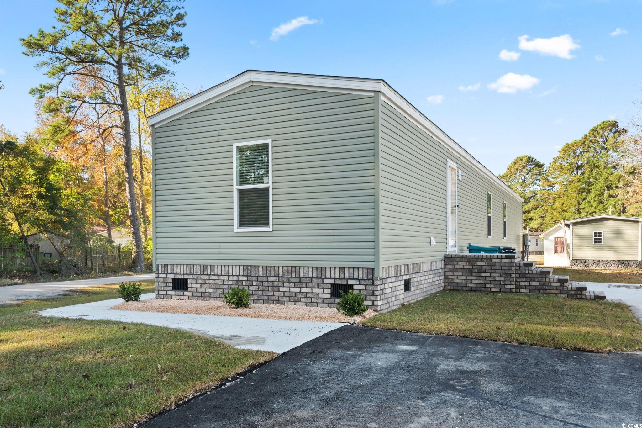 4448 Flat Bay Circle Myrtle Beach, SC 29588 - Photo 27 of 30 View of side of property featuring a yard and crawl space