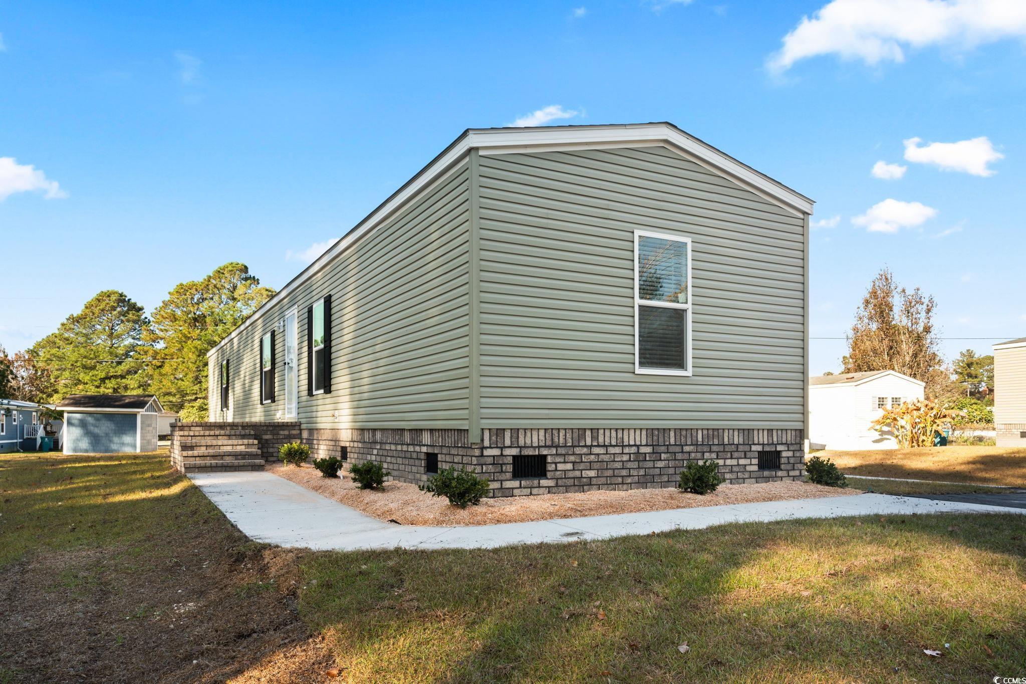 4448 Flat Bay Circle Myrtle Beach, SC 29588 - Photo 29 of 30 View of home's exterior with crawl space and a lawn