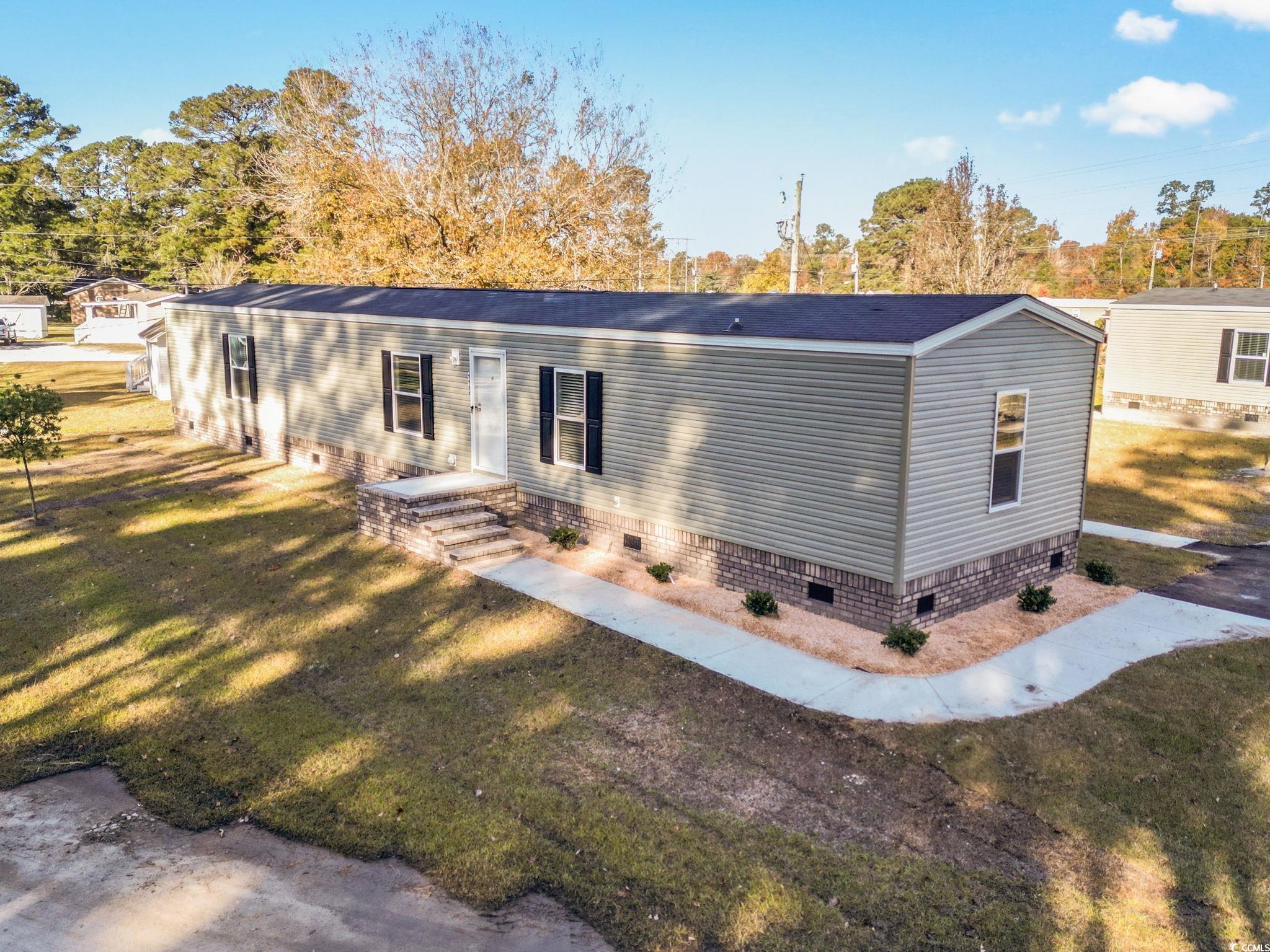 4448 Flat Bay Circle Myrtle Beach, SC 29588 - Photo 5 of 30 View of front of home featuring crawl space and a front lawn