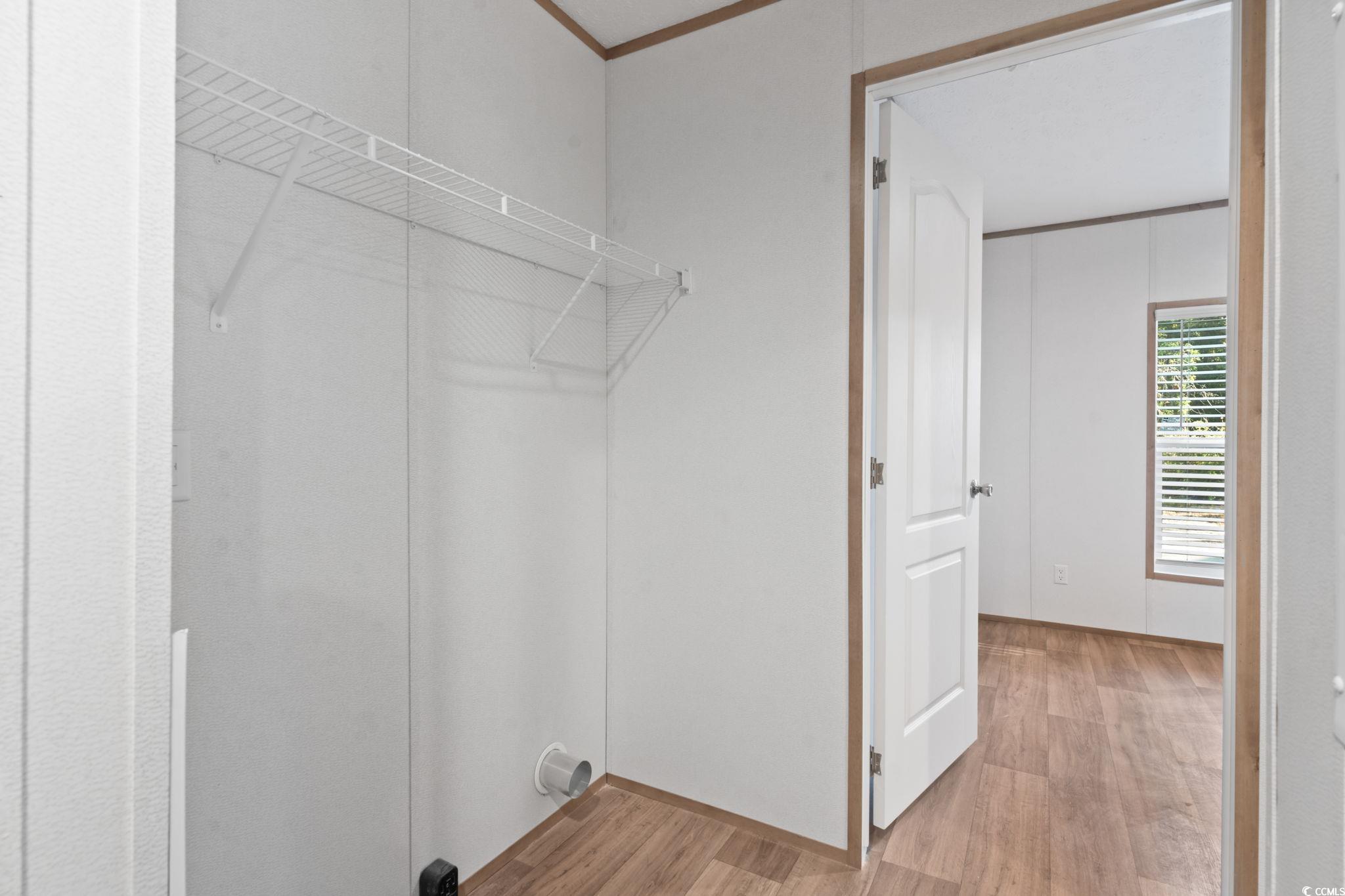 4448 Flat Bay Circle Myrtle Beach, SC 29588 - Photo 9 of 30 Washroom with light wood-style flooring and ornamental molding