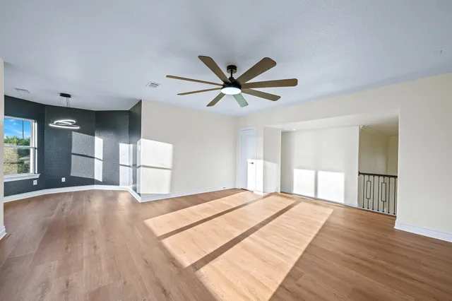 a view of a livingroom with a hardwood floor and a ceiling fan