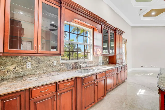 a view of empty room with wooden floor and window