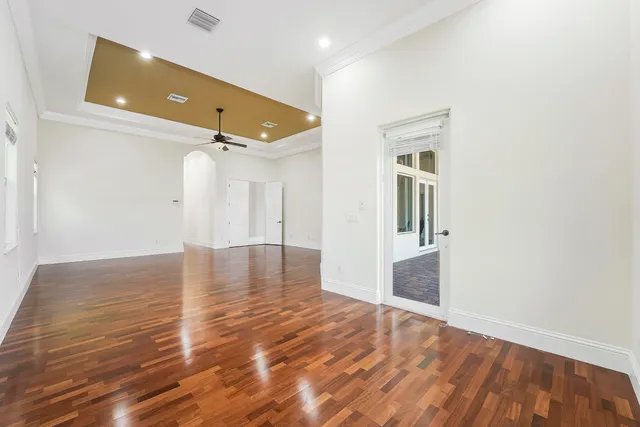 a bedroom with a large bed and a chandelier