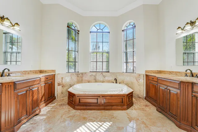 an empty room with wooden floor ceiling fan and window
