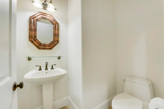 a view of swimming pool with lawn chairs and plants