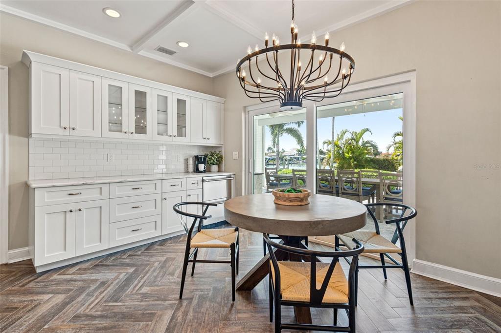 511 Windward Passage Clearwater Beach, FL 33767 - Photo 12 of 40 a view of a dining room with furniture window and wooden floor