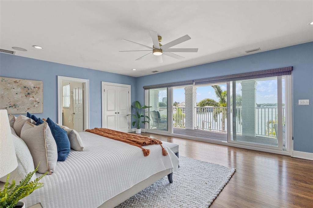 511 Windward Passage Clearwater Beach, FL 33767 - Photo 15 of 40 a spacious bedroom with a large bed and a large window