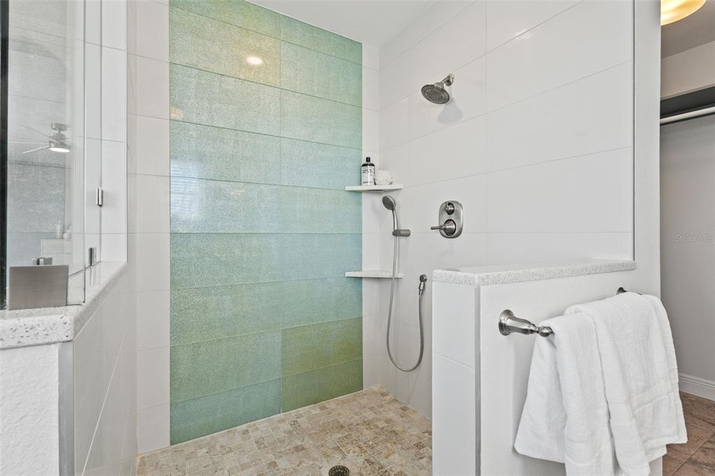 511 Windward Passage Clearwater Beach, FL 33767 - Photo 19 of 40 a bathroom with a sink and shower