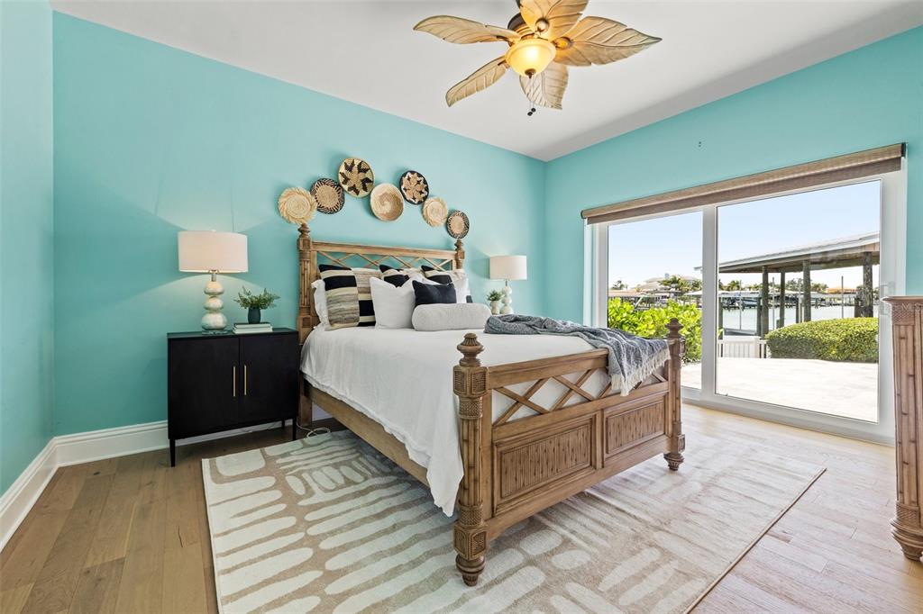 511 Windward Passage Clearwater Beach, FL 33767 - Photo 20 of 40 a bedroom with a bed and a chandelier