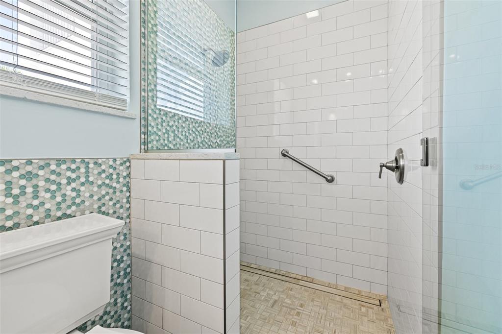 511 Windward Passage Clearwater Beach, FL 33767 - Photo 22 of 40 a bathroom with a toilet and shower