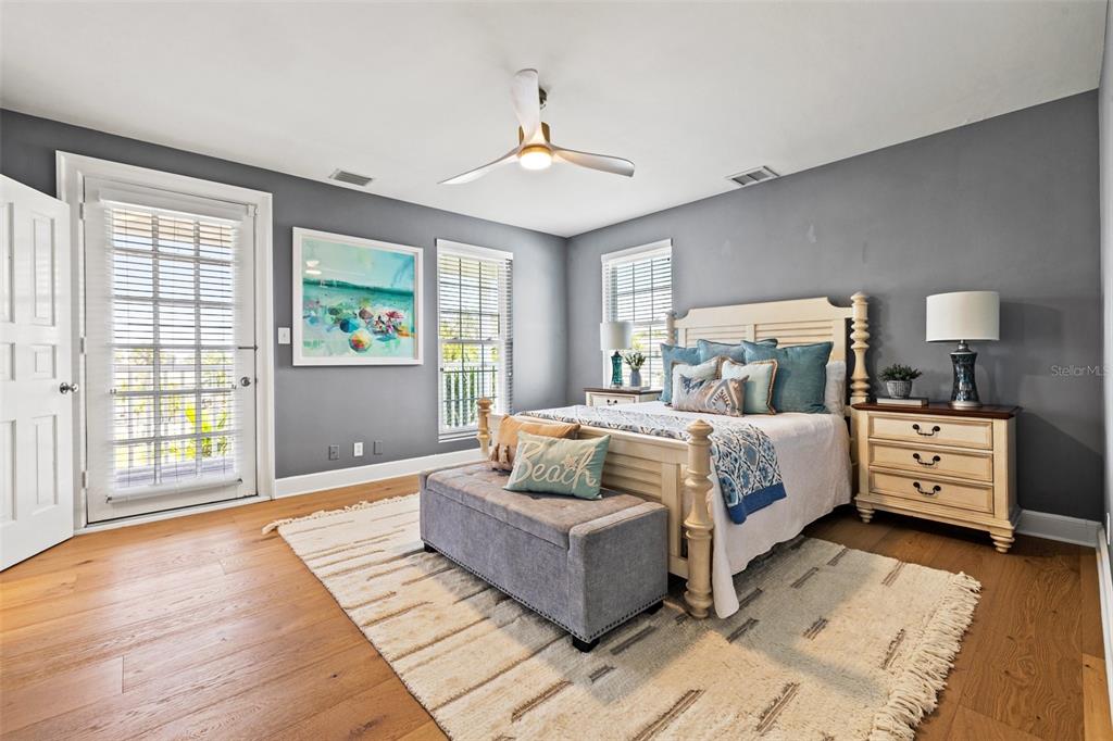 511 Windward Passage Clearwater Beach, FL 33767 - Photo 25 of 40 a bedroom with a large bed and a couch