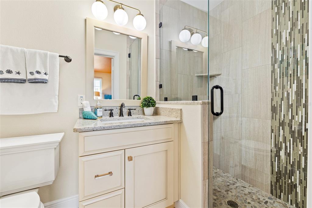 511 Windward Passage Clearwater Beach, FL 33767 - Photo 28 of 40 a bathroom with a sink vanity granite and a mirror