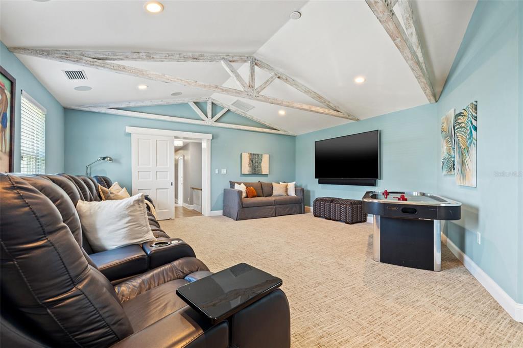 511 Windward Passage Clearwater Beach, FL 33767 - Photo 30 of 40 a living room with furniture and a flat screen tv