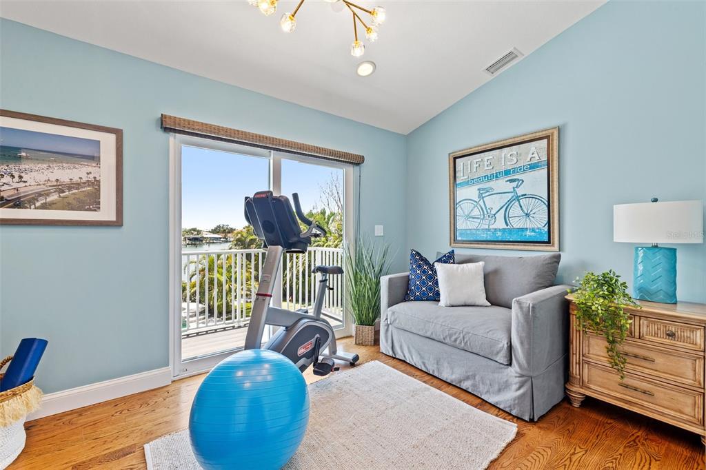 511 Windward Passage Clearwater Beach, FL 33767 - Photo 31 of 40 a living room with furniture a chandelier and a wooden floor