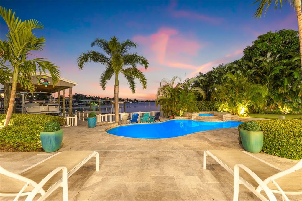 511 Windward Passage Clearwater Beach, FL 33767 - Photo 33 of 40 a view of swimming pool with outdoor seating and plants