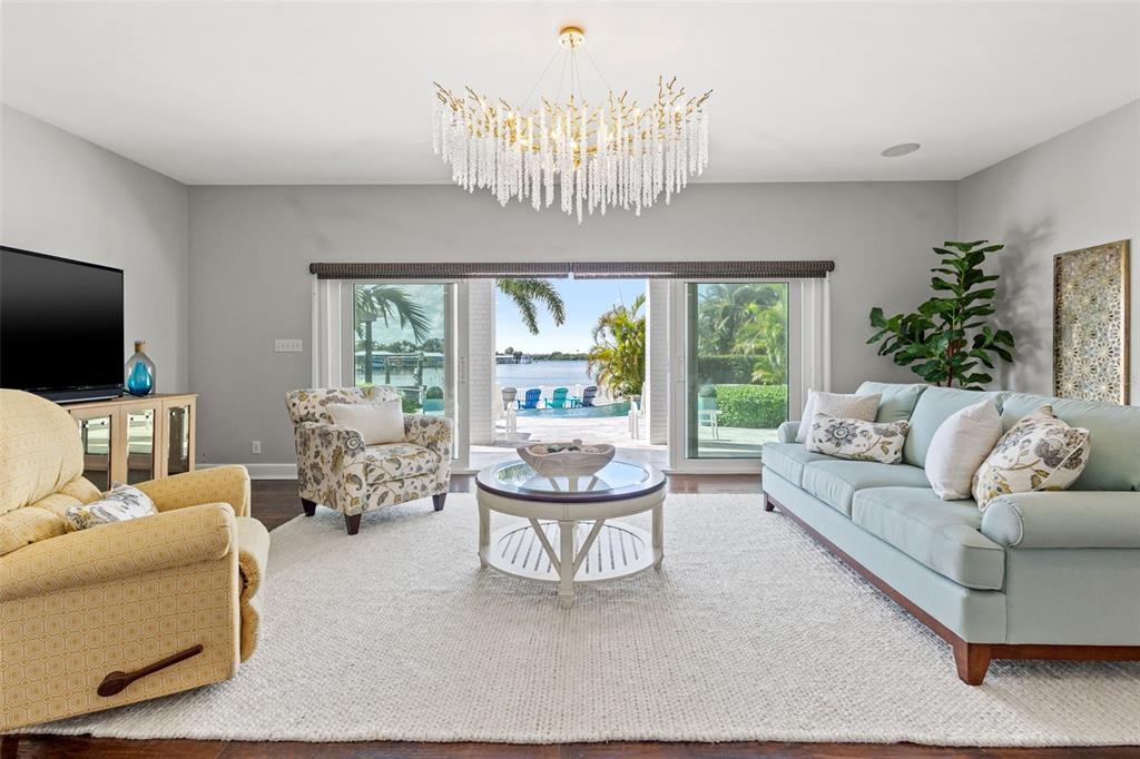 511 Windward Passage Clearwater Beach, FL 33767 - Photo 5 of 40 a living room with furniture a flat screen tv and a large window
