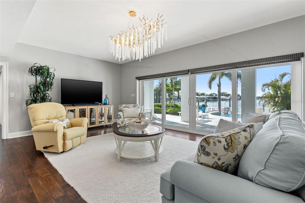511 Windward Passage Clearwater Beach, FL 33767 - Photo 7 of 40 a living room with fireplace furniture and a flat screen tv