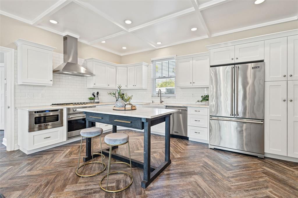 511 Windward Passage Clearwater Beach, FL 33767 - Photo 10 of 40 a kitchen with stainless steel appliances a stove a sink and a refrigerator
