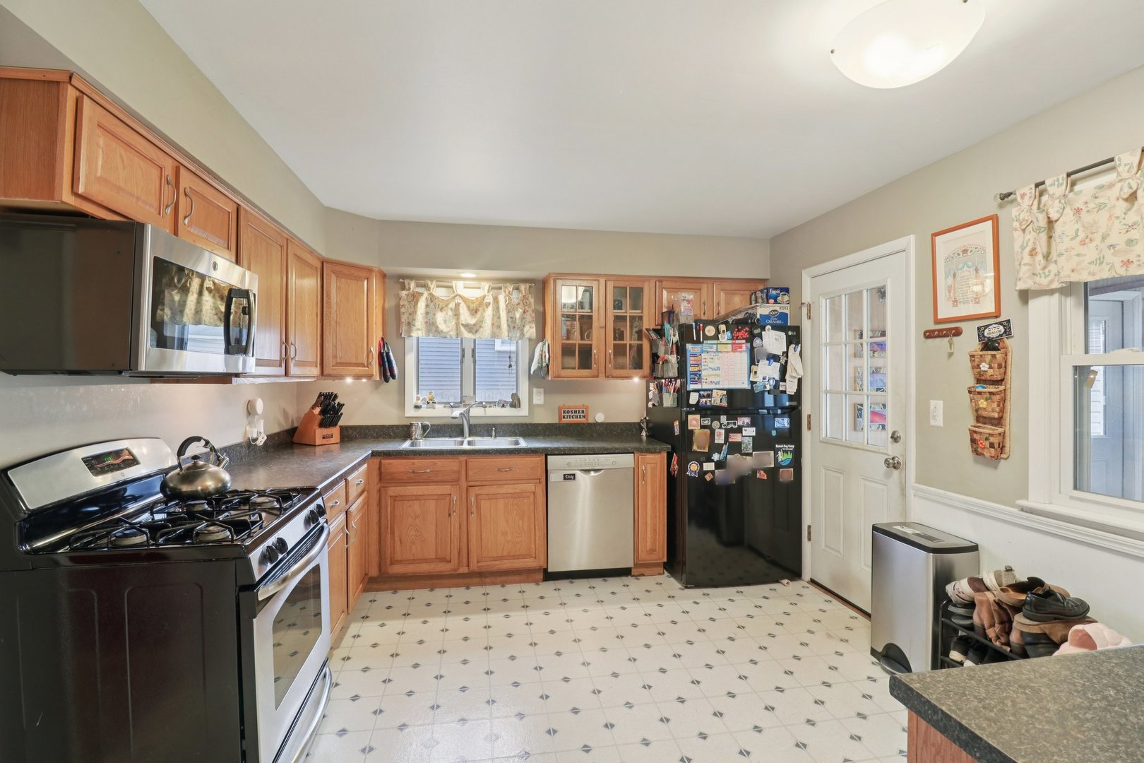 610 Maple Drive Buffalo Grove, IL 60089 - Photo 11 of 39 a kitchen with a sink stove and refrigerator