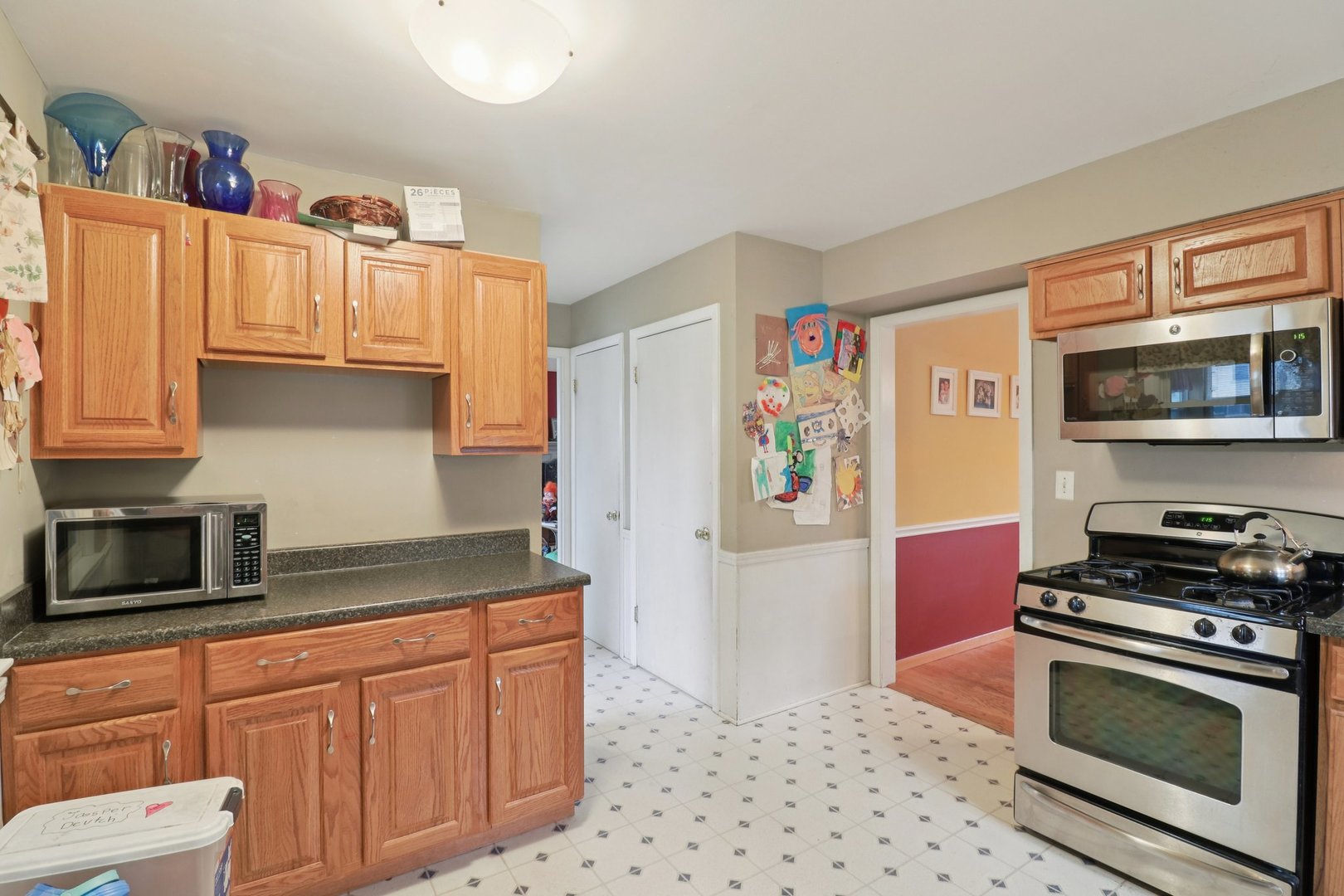 610 Maple Drive Buffalo Grove, IL 60089 - Photo 14 of 39 a kitchen with stainless steel appliances granite countertop a refrigerator and a stove top oven