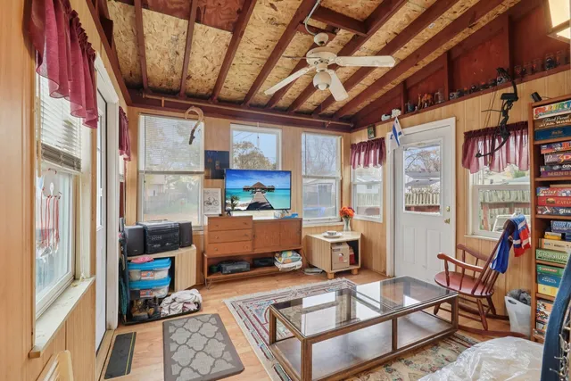 a living room with furniture a window and a wooden floor